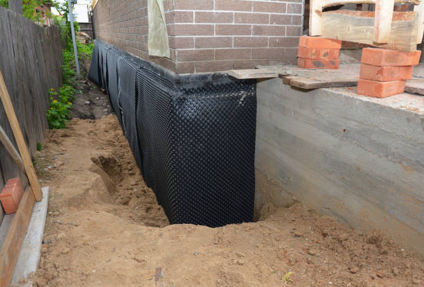 SJ Waterproofing Pros technician performing targeted Exterior Waterproofing assessment in Livonia, NY